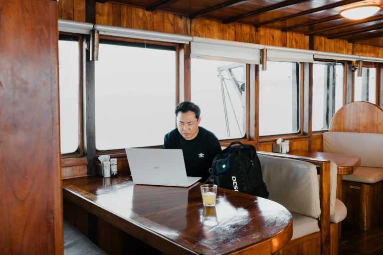 Guest enjoying internet with a laptop while onboard