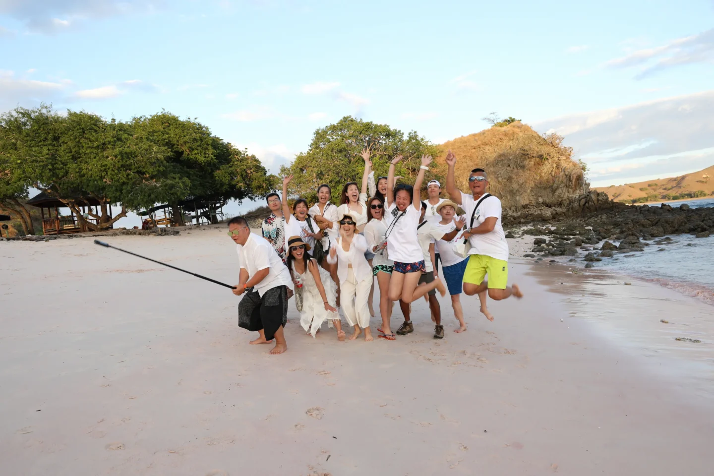 A group of people having fun on pink beach in Komodo