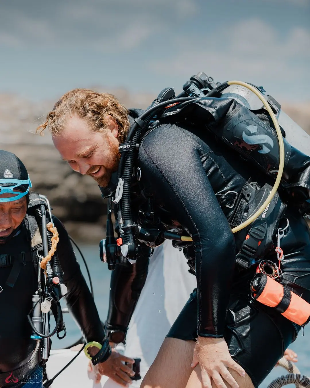 Happy scuba diver beaming with joy post-dive aboard La Galigo Liveaboard in Indonesia.