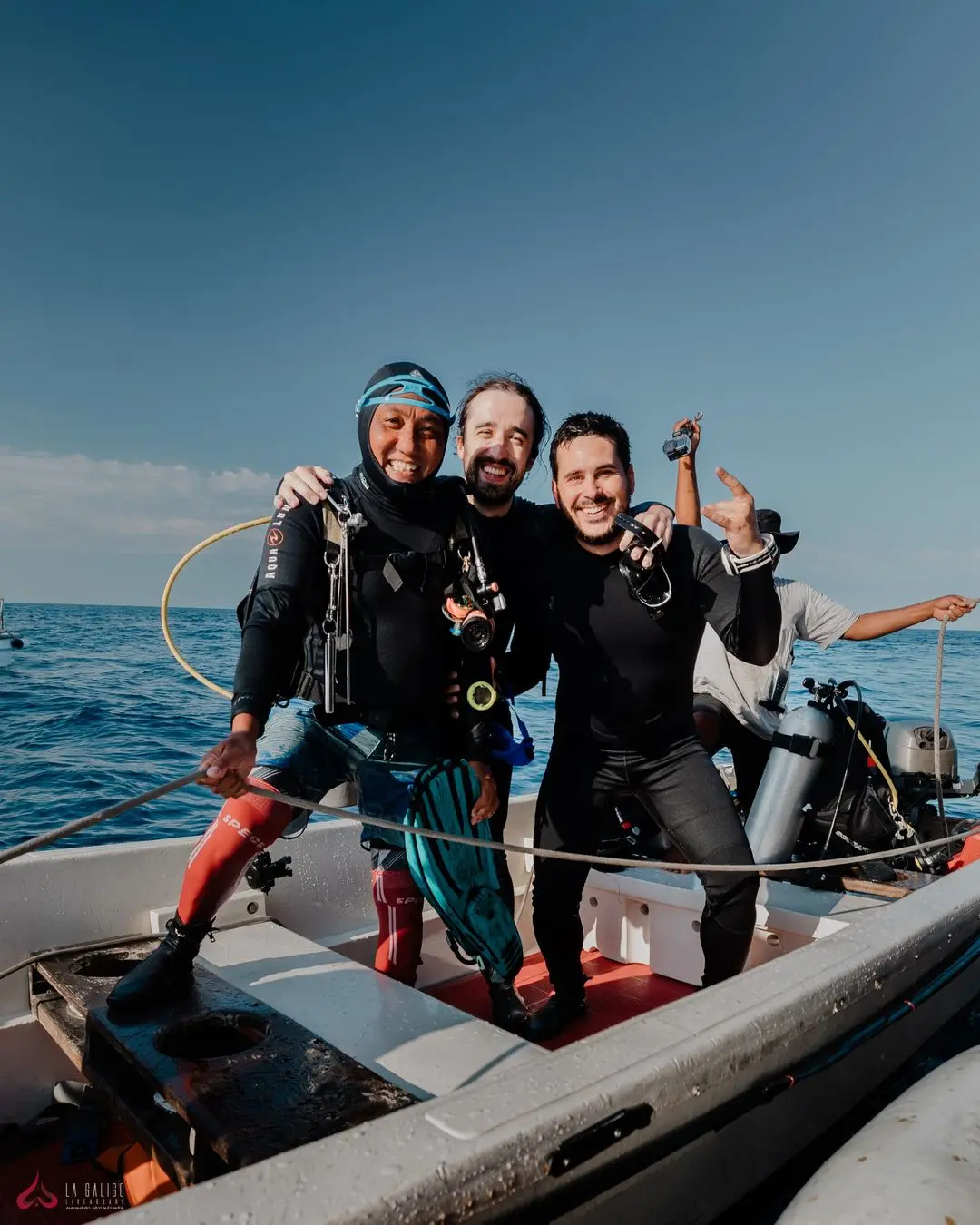 Trio of divers enjoying a lively speedboat ride back to La Galigo after a successful dive.