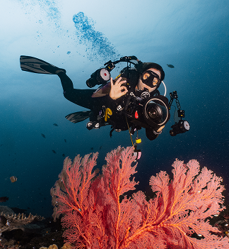 Underwater photographer preparing camera equipment
