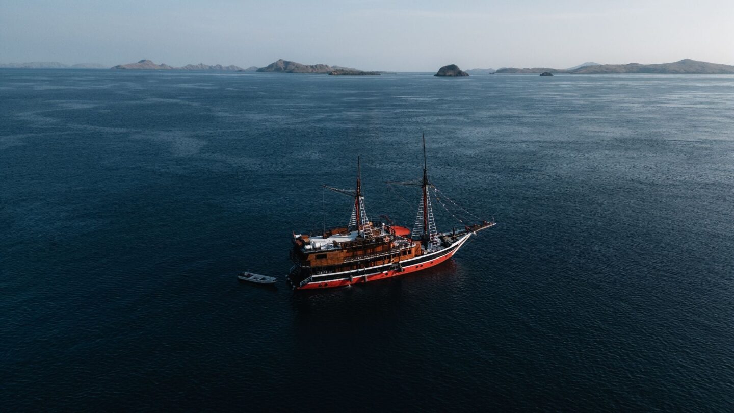 La Galigo liveaboard sailing through Sumbawa waters during a multi-day diving expedition, highlighting remote island scenery and access to lesser-visited dive sites